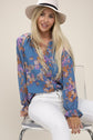 women wearing Floral teal blue Chiffon Blouse with collar and V neck. 