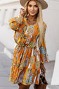 Woman wearing a She is All That Tangerine Printed Flounce Sleeve Dress