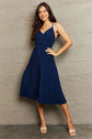 women wearing a navy Tie Back Spaghetti Strap Pleated Dress