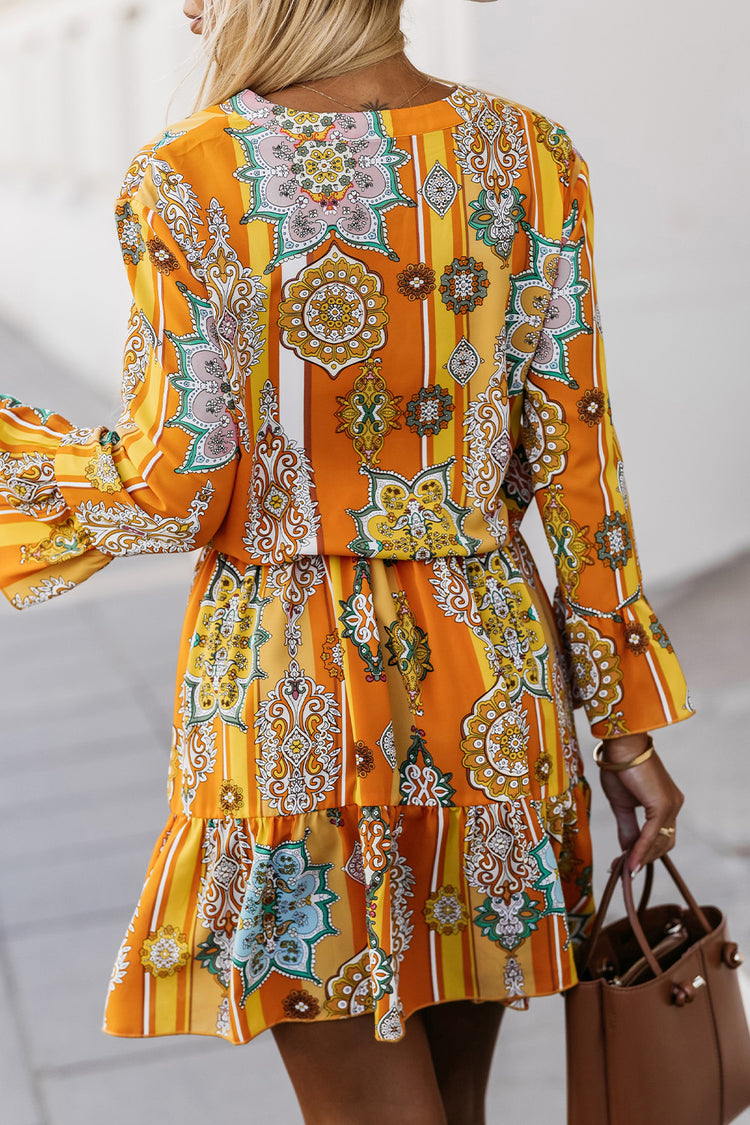 Woman wearing a She is All That Tangerine Printed Flounce Sleeve Dress