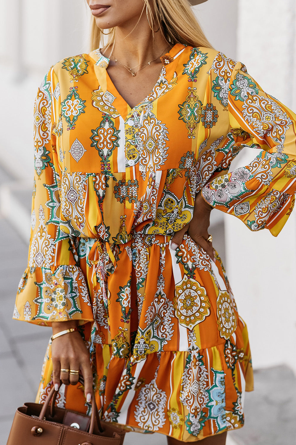 Woman wearing a She is All That Tangerine Printed Flounce Sleeve Dress